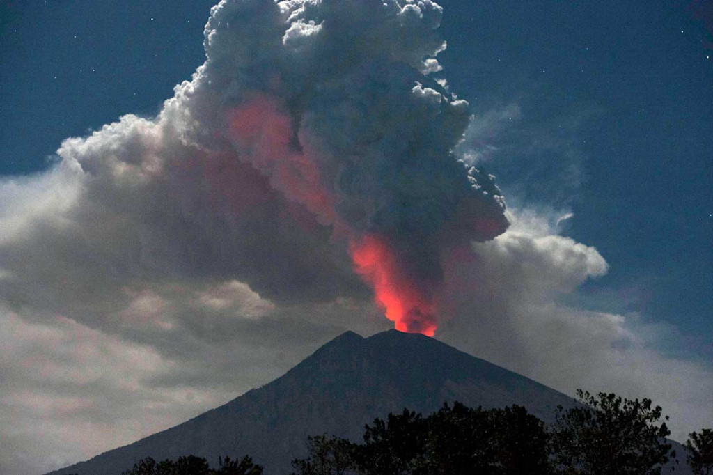 Cahaya magma dalam kawah Gunung Agung terpantul pada abu vulkanis terlihat dari Desa Datah, Karangasem, Bali, Jumat, 29 Juni 2018. 