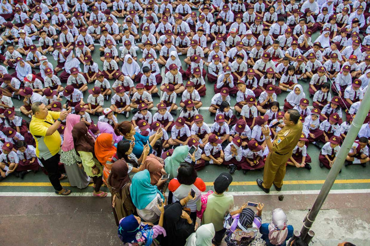 Gubernur DKI Jakarta Anies Baswedan (kanan) memberikan sambutan saat meninjau pelaksanaan kegiatan masa pengenalan lingkungan sekolah (MPLS) di SDN Kampung Melayu 01/02, Bidara Cina, Jakarta. Antara Foto/Galih Pradipta