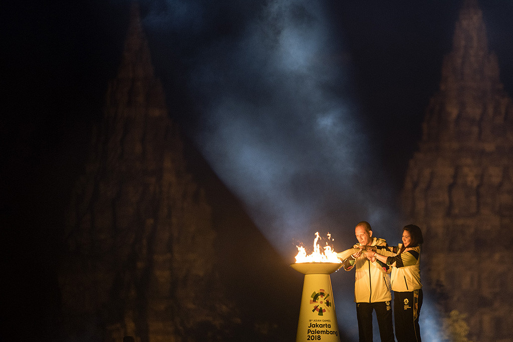 Legenda bulu tangkis Indonesia Susi Susanti (kanan) dan mantan atlet tenis Yustedjo Tarik (kiri) mengambil api obor Asian Games 2018 yang telah disatukan saat Asian Games 2018 Torch Relay Concert di Kompleks Candi Prambanan, Sleman, DI Yogyakarta.
