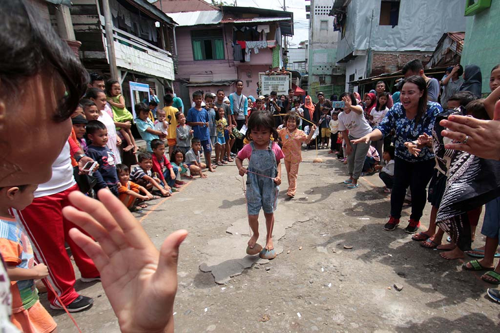 Sejumlah anak-anak mengikuti lomba 'egrang' batok kelapa di kampung Aur Medan, Sumatera Utara. Dalam rangka memperingati Hari Anak Nasional 2018, warga di kampung itu menggelar berbagai lomba permainan tradisional yang bertujuan untuk melestarikan permainan yang nyaris dilupakan dan jarang dimainkan anak-anak. Antara Foto/Septianda Perdana
