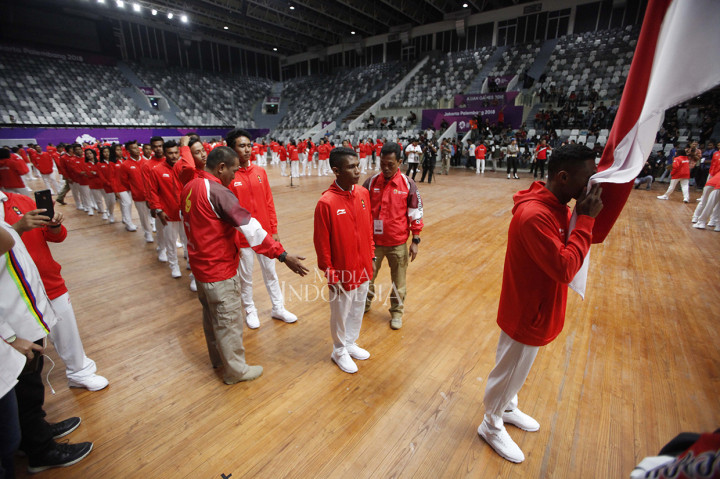 Para atlet dan ofisial melakukan ritual mencium bendera merah putih ketika acara Pengukuhan Kontingen Asian Games 2018 ddi Istora Gelora Bung Karno, Senayan, Jakarta.
