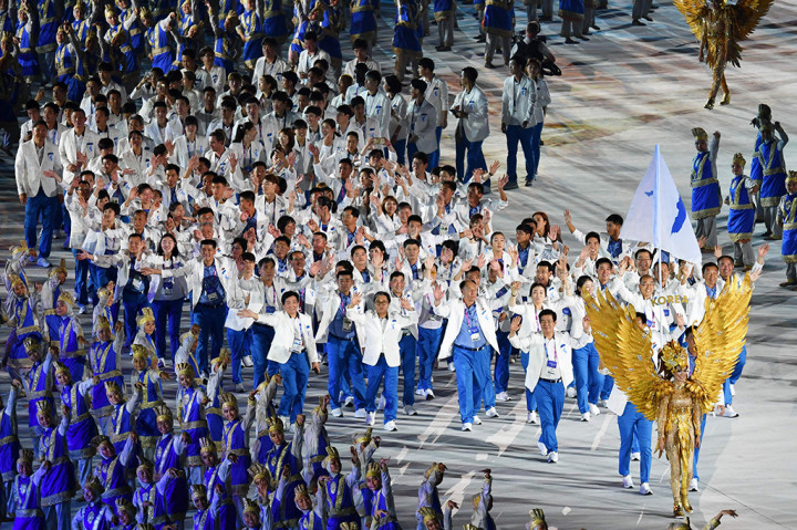 Momen kontingen Korea Utara dan Korea Selatan yang saling bergandengan tangan juga tak kalah mencuri perhatian. Afp Photo/Adek Berry