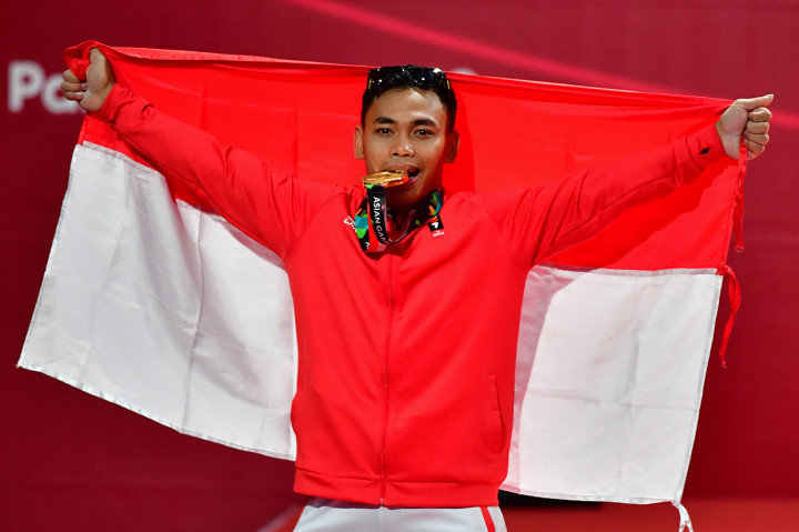 Lifter Eko Yuli irawan menyumbang medali emas untuk Indonesia dengan melakukan angkatan total 311 kg (snatch 141 dan clean and jerk 170). Ini merupakan medali emas pertama angkat besi Indonesia pada Asian Games. Afp Photo/Money Sharma