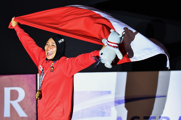 Bagi Aries Susanti Rahayu, perolehan ini merupakan emas kedua yang diraihnya. Sebelumnya, dia juga meraih emas pada nomor individu kecepatan putri. Foto diambil 23 Agustus 2018. Afp Photo/Adek Berry