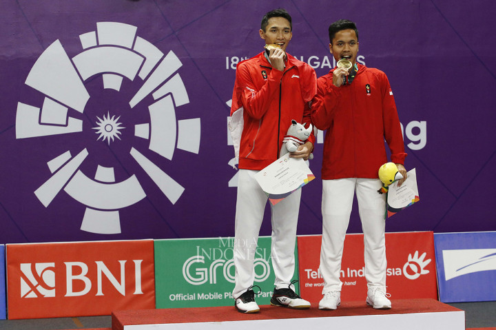 Pebulu tangkis nasional Jonatan Christie dan Anthony Ginting menunjukkan medali emas dan perunggu yang diraihnya seusai mengalahkan pebulu tangkis Taiwan Tienchen Chou pada final bulu tangkis tunggal putra Asian Games 2018 di Istora Senayan, Komplek GBK, Jakarta, Selasa (28/8). Jojo menambah raihan medali emas Indonesia setelah kalahkan lawannya dengan skor 2-1 (21-18, 20-22 dan 21-15). MI/Rommy Pujianto