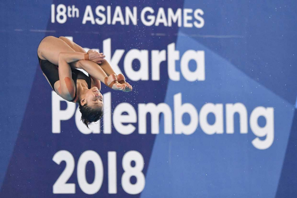 Atlet Malaysia Pamg Pandelela melakukan loncatan pada cabagn loncat indah. AFP Photo/Peter Parks