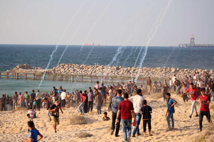 Demonstran melempar batu dan membakar ban di dekat pagar perbatasan. Sementara itu, tentara Israel menggunakan gas air mata dan menembakkan peluru aktif untuk mengusir mereka.