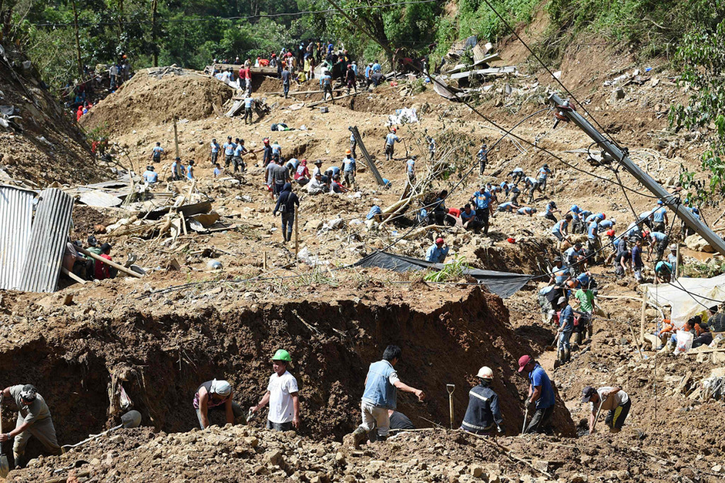 Para petugas pencari hari ini terus melakukan upaya pencarian korban di antara timbunan lumpur yang menimpa tempat-tempat tinggal yang digunakan para penambang berskala kecil.