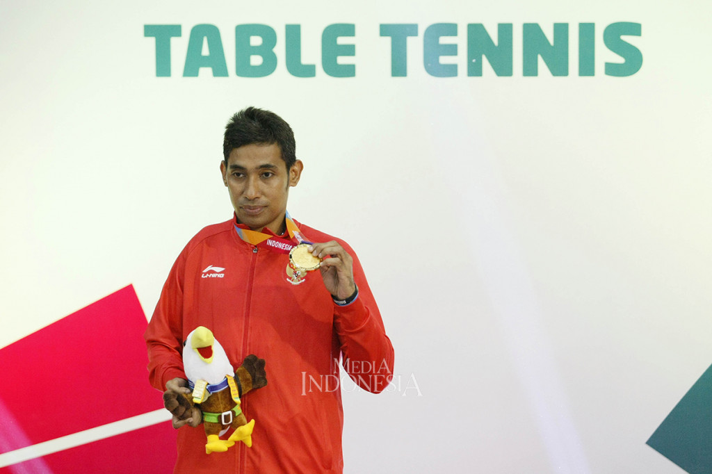 Petenis meja Indonesia David Jacobs menunjukkan medali emas yang diraihnya seusai menang atas lawannya petenis meja Tiongkok Lian Hao pada final tenis meja tunggal putra TT10 Asian Para Games 2018 di Ecovention Ancol, Jakarta.