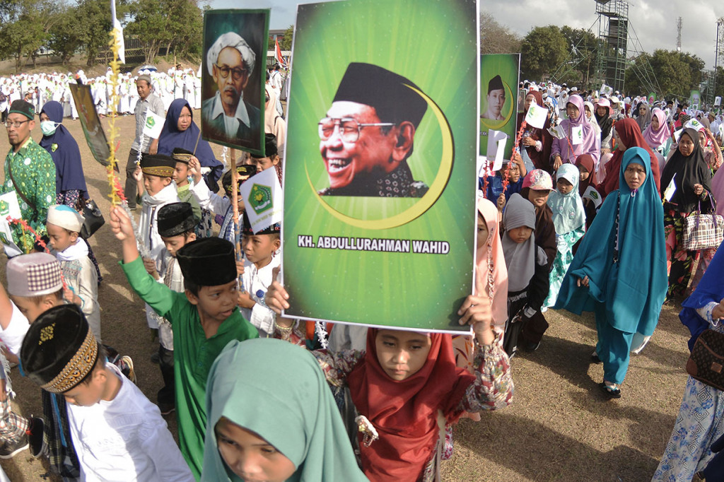Sejumlah warga mengikuti kirab kebangsaan dalam rangkaian peringatan Hari Santri Nasional di kawasan Kuta, Badung, Bali. Kegiatan yang diikuti ribuan peserta tersebut digelar untuk memperingati Hari Santri Nasional 2018 sekaligus untuk menanamkan rasa cinta dan kebanggaan terhadap Negara Kesatuan Republik Indonesia. Antara Foto/Fikri Yusuf