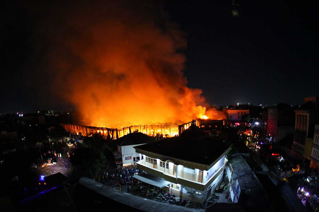 Kebakaran besar terjadi di dalam pasar bagian barat utara. Puluhan pedagang dibantu masyarakat sekitar terlihat menyelamatkan barang dagangan mereka.
