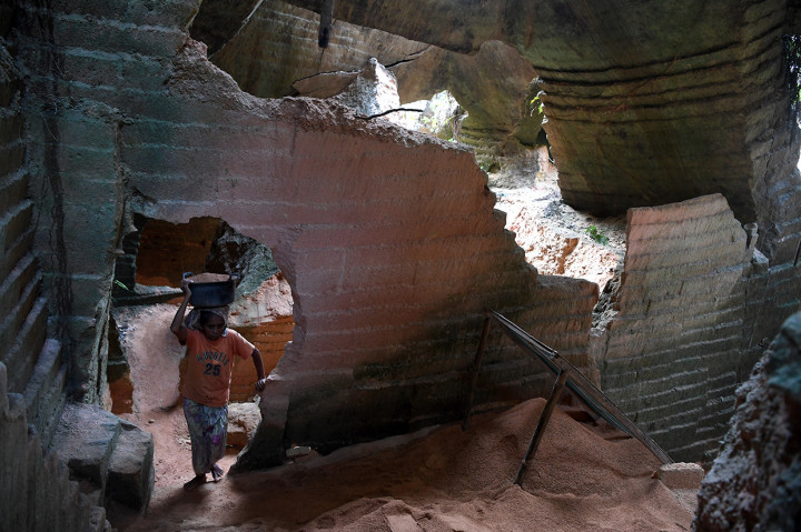 Pekerja membawa pasir batu kapur untuk dijadikan bahan bangunan di Tambang Batu Kapur Arosbaya, Bangkalan, Jawa Timur.