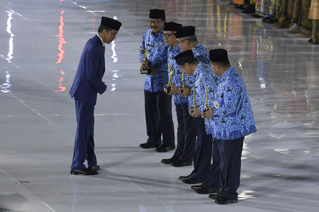Presiden Joko Widodo menyerahkan penghargaan KORPRI Award pada peringatan Hari Ulang Tahun Korps Pegawai Republik Indonesia (KORPRI) ke-47 di Istora Senayan, Jakarta.