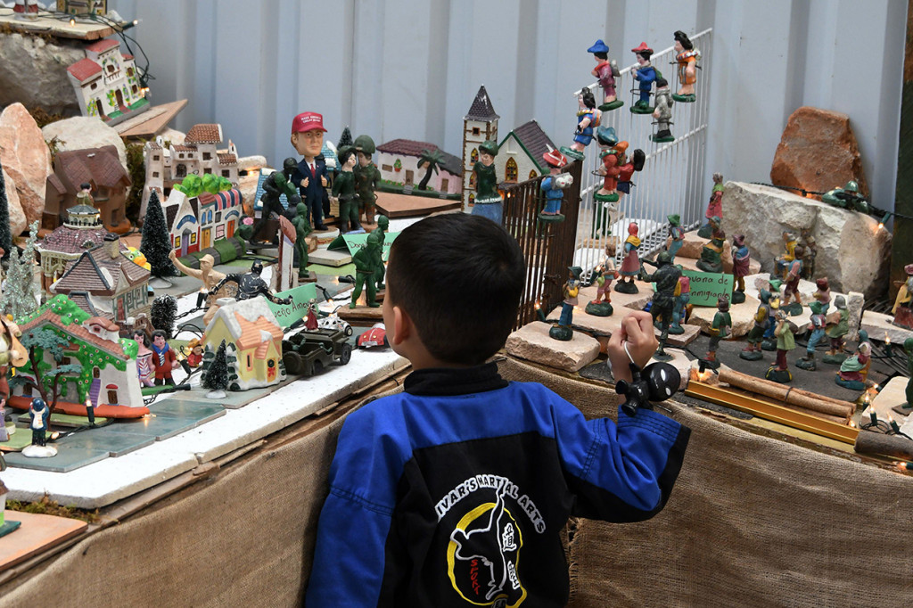 Seorang anak melihat representasi atau miniatur imigran Honduras di Mal Tegucigalpa.