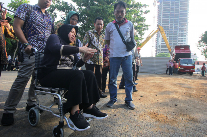 Walkot Tri Risma harus berkursi roda akibat pergelangan kakinya terkilir. “Ini masih sakit. Tapi kalau nggak gini (turun ke lapangan -red) ya nggak cepet-cepet pengerjaannya,