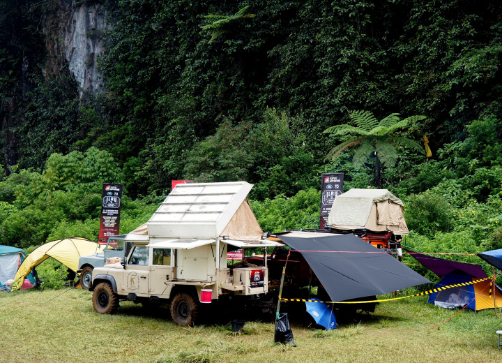 Land Rover yang telah dimodifikasi sedemikian rupa menjadi camper. Tenda tempat tidur ada di atap dan dapur ada di bagian belakang.