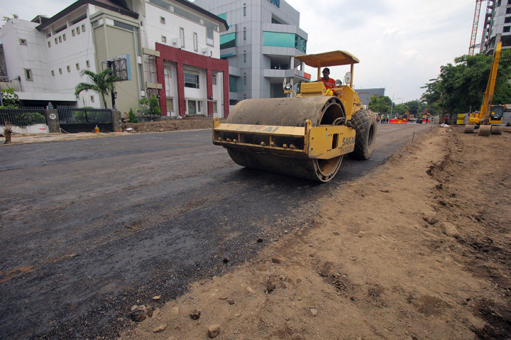 Pekerja memadatkan urukan tanah di lokasi jalan ambles di Jalan Raya Gubeng, Surabaya, Jawa Timur, Rabu, 26 Desember 2018.