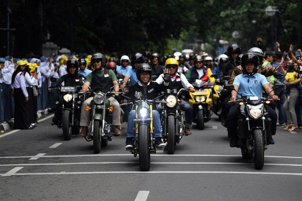Presiden Joko Widodo melakukan sunmori (sunday morning ride) keliling Tangerang dengan mengendarai sepeda motor custom bergaya bobber. Sebelumnya aksi serupa dilakukannya dengan turing ke Sukabumi menggunakan sepeda motor chopper custom warna emas. Selain detail teknis tunggangnnya, jaket yang dikenakan Jokowi juga menjadi bahan ‘debat kusir’ bertendensi politis antara kelompok ‘cebong’ vs ‘kampret’.  Antara Foto/Wahyu Putro A 