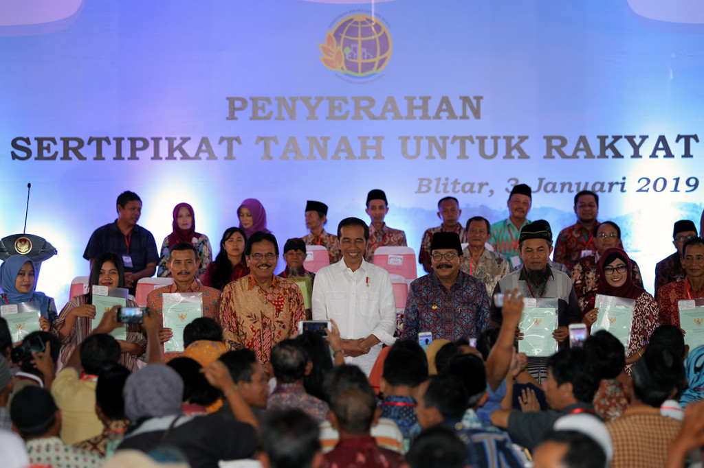 Presiden RI Joko Widodo didampingi Menteri Agraria dan Tata Ruang/Kepala Badan Pertanahan Nasional (ATR/BPN) Sofyan Djalil dan Gubernur Jawa Timur Soekarwo berfoto bersama perwakilan warga penerima sertifikat tanah saat penyerahan di Pendopo Sasana Adhi Praja, Blitar, Jawa Timur.