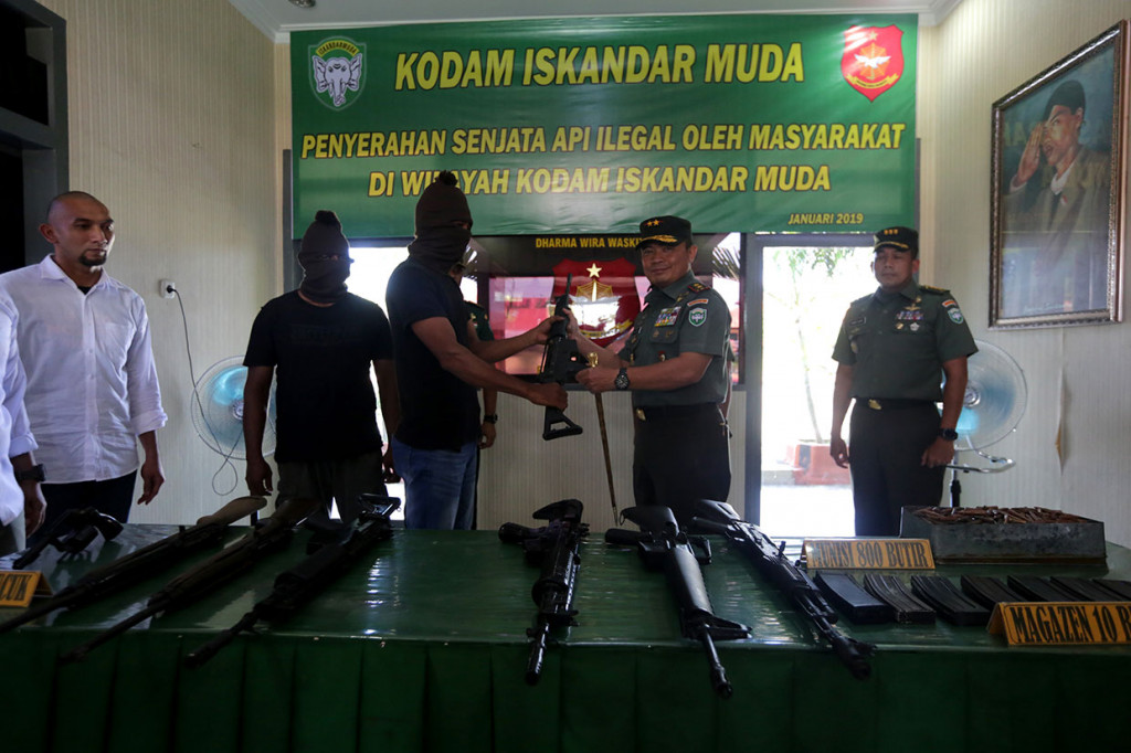 Panglima Kodam Iskandar Muda Mayjen Teguh Arief Indratmoko (dua kanan) menerima senjata api yang diserahkan warga di Mako Detasemen Intel (Denitel) Lampineung, Banda Aceh, Aceh, Kamis, 3 Januari 2019. 