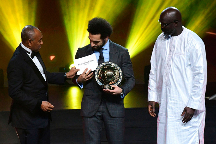 Presiden Konfederasi Sepak Bola Afrika (CAF) Ahmad Ahmad (kiri) didampingi Presiden Liberia George Weah menyerahkan Penghargaan Pemain Terbaik Afrika 2018 kepada penyerang Mesir Mohamed Salah dalam upacara penghargaan di Dakar, Senegal, Selasa, 9 Januari 2019 waktu setempat.