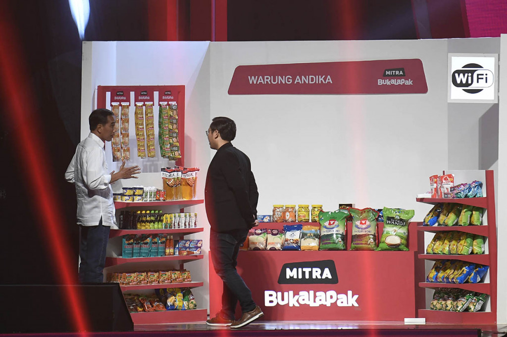 Presiden Joko Widodo (kiri) didampingi Founder dan CEO Bukalapak Achmad Zaky (kanan) meninjau stan warung mitra Bukalapak saat Perayaan HUT ke-9 Bukalapak di Jakarta.