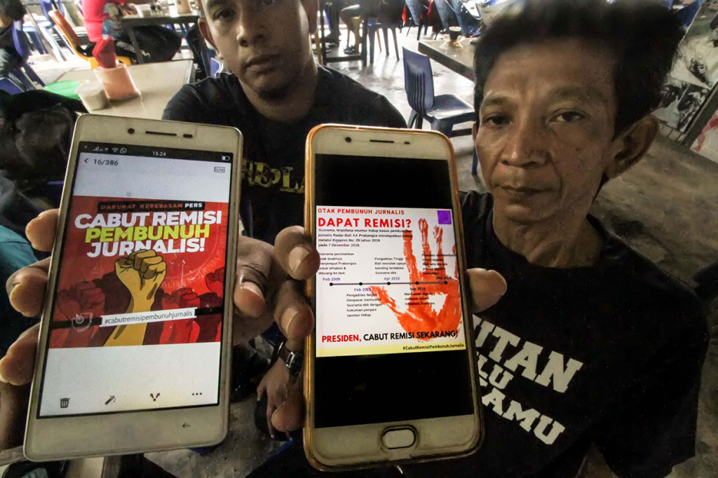 Ketua Aliansi Jurnalis Independen (AJI) Lhokseumawe Agustiar Ismail (kanan) dan Ketua Advokasi AJI Khaidir menujukkan seruan 'Cabut Remisi Pelaku Pembunuh Jurnalis' di Lhokseumawe, Aceh, Kamis. Antara Foto/Rahmad