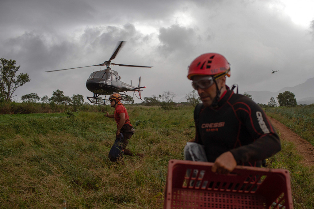 Tim SAR langsung bergerak cepat melakukan pertolongan dan evakuasi. Lusinan helikopter diterjunkan dalam operasi penyelamatan, karena lumpur yang menejrang kawasan di bawahnya menelan bangunan, kendaraan, dan jalan. Afp Photo/Mauro Pimentel