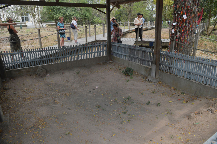 Wisatawan melihat bekas kuburan massal para korban pembantaian rezim komunis Khmer Merah di Monumen Choeung Ek.