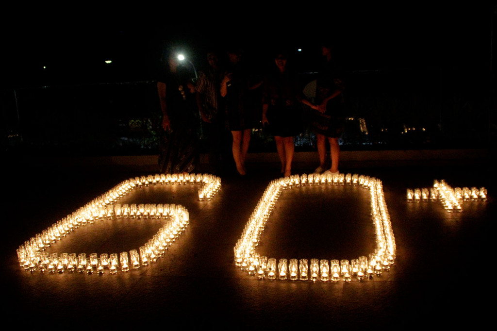 Karyawan menyalakan lilin membentuk angka 60 plus saat peringatan Earth Hour di sebuah hotel di Kupang, NTT. Antara Foto/Kornelis Kaha
