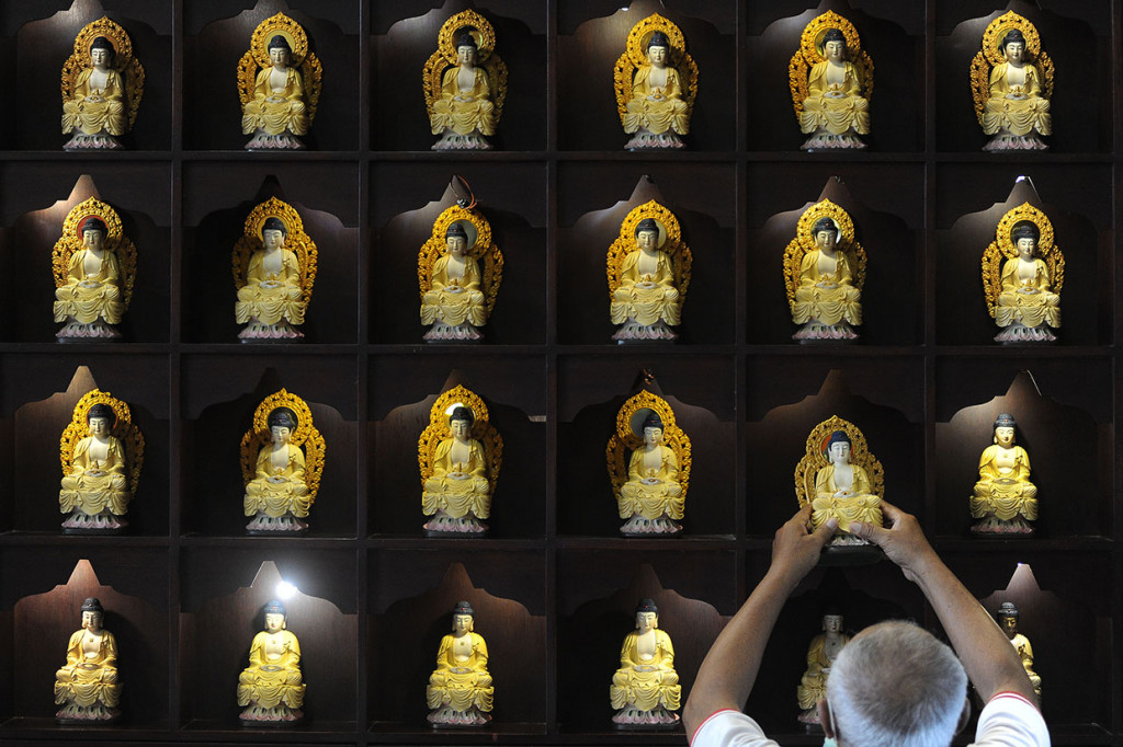 Petugas membersihkan Rupang Buddha di Vihara Buddha Dharma, Kuta, Bali. Antara Foto/Fikri Yusuf