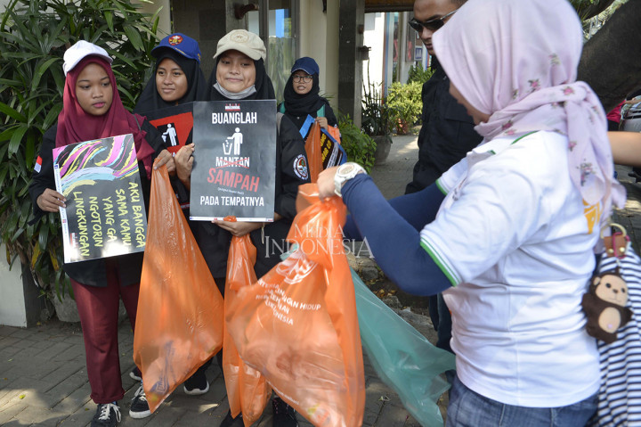 Para relawan yang tergabung dalam relawan Millenial Pengawas Sampah plastik membagi-bagikan kantong sampah plastik biodegradable yang dapat cepat terurai saat kampnye Mudik Asik Tampa Sampah Plastik di Rest Area KM 19 Tol Jakarta-Cikampek.