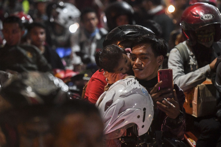 Pengendara motor tujuan Sumatra berfoto bersama anaknya saat antre memasuki kapal Roro di Pelabuhan Merak, Banten. Antara Foto/Hafidz Mubarak A