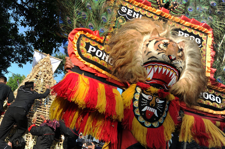 Seniman menampilkan tari Reog Ponorogo saat warga berebut ketupat dalam Festival 1.001 Ketupat di Desa Kalimalang, Ponorogo, Jawa Timur.