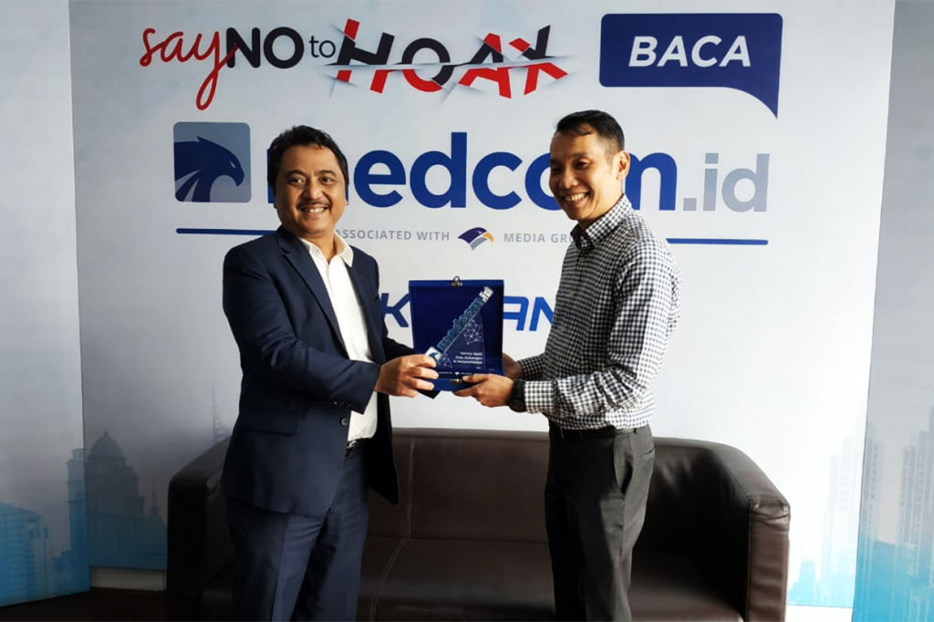 Direktur Konten dan Redaksi Medcom.id Abdul Kohar bertukar cendera mata dengan Chief Executive of BMW Sales Operational Fredy Handjaja Elawitachya.