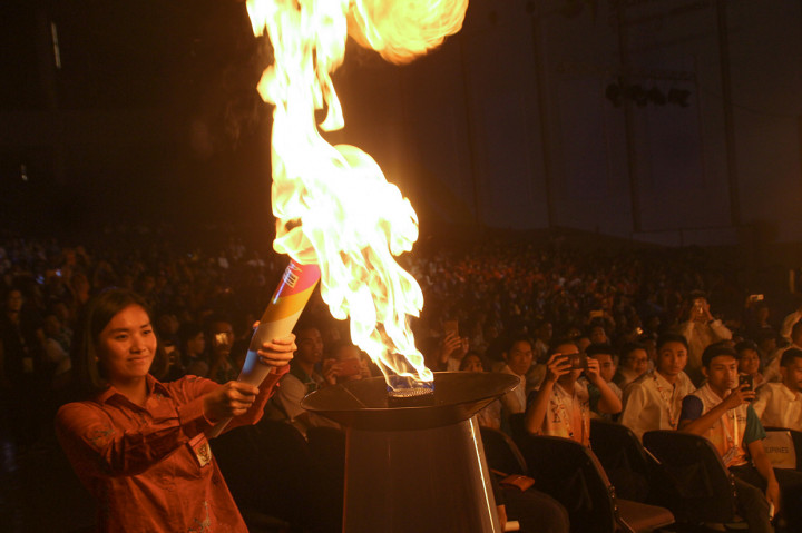 Atlet putri bola voli Indonesia untuk ASEAN Schools Games, Cantika (kiri) menyalakan api kaldron pada pembukaan ASEAN Schools Games XI Tahun 2019 di Holy Stadium Terang Bangsa School, Semarang, Jawa Tengah.