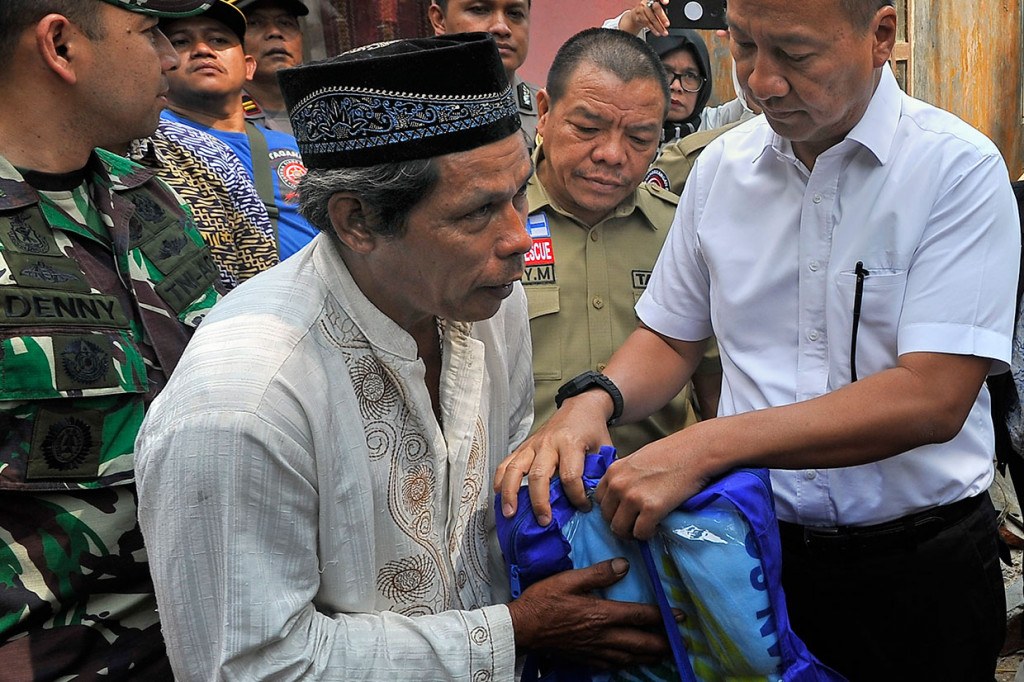 Menteri Sosial Agus Gumiwang Kartasasmita (tengah) secara simbolis menyerahkan bantuan kepada warga korban gempa Banten di Kampung Panjangjaya, Mandalawangi, Pandeglang, Banten, Sabtu, 3 Agustus 2019. 