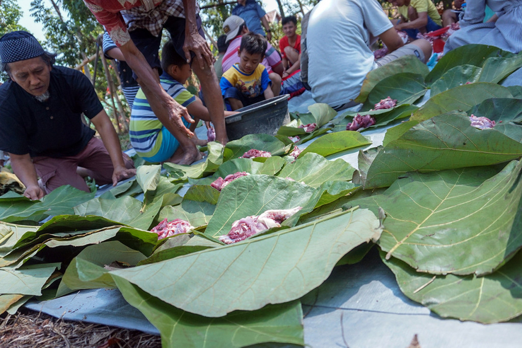 Warga memilah daging kurban menggunakan daun pohon jati usai dilakukan pemotongan di Perumahan Lebo Permai, Warungasem, Kabupaten Batang, Jawa Tengah. Antara Foto/Harviyan Perdana Putra
