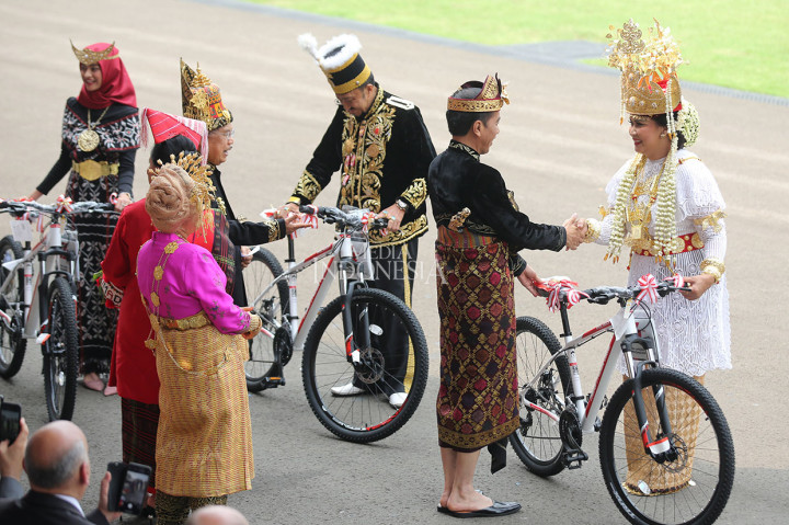 Presiden Jokowi menyerahkan hadiah sepeda kepada istri Menteri Pertahanan Ryamizard Ryacudu, Nora Tristyana, pemenang ketiga busana adat terbaik yang dikenakan undangan seusai Upacara Peringatan Detik-Detik Proklamasi Kemerdekaan ke-74 Republik Indonesia di halaman Istana Merdeka, Jakarta, Sabtu, 17 Agustus 2019.