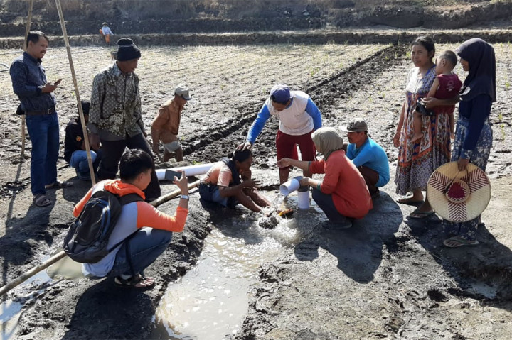 Warga ramai-ramai mendatangi lokasi sumur bor yang menyemburkan air cukup deras di tengah lahan pertanian tandus di Dusun Widoro Lor, Desa Bendungan, Kecamatan Semin, Gunung Kidul, Yogyakarta, Jumat, 23 Agustus 2019.