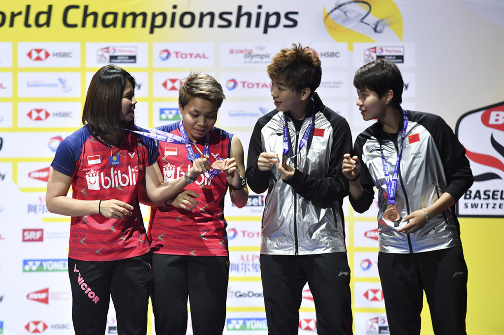 Ganda Putri Indonesia Greysia Polii (kiri) dan Apriyani Rahayu bersama ganda putri China Du Yue dan Li Yinhui melihat medali di atas podium saat prosesi penyerahan medali pada Kejuaraan Dunia Bulu Tangkis 2019 di St. Jakobshalle, Basel, Swiss.