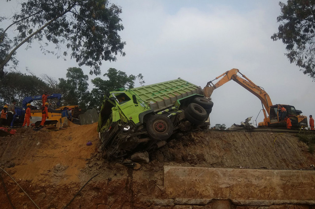 Petugas mengevakuasi salah satu kendaraan yang terlibat pada kecelakaan beruntun di Tol Cipularang KM 92 Purwakarta, Jawa Barat.