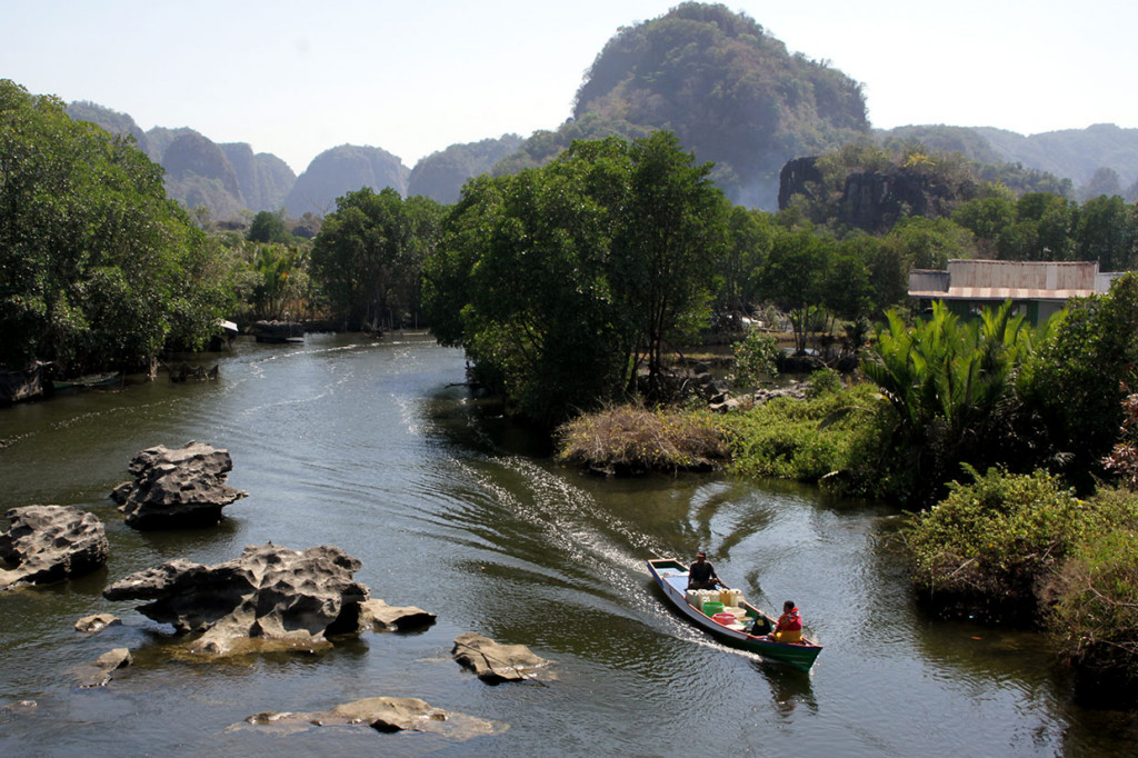 Warga melintasi Sungai Pute dengan menggunakan perahu di kawasan Pegunungan Karst Rammang-Rammang, Desa Salenrang, Maros, Sulawesi Selatan, Sabtu, 14 September 2019.