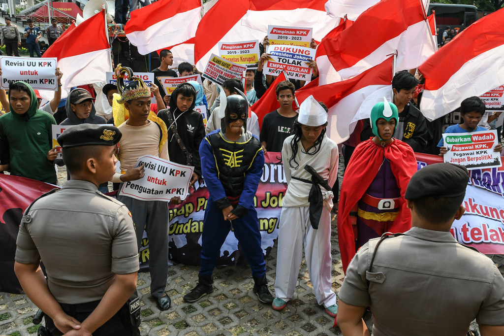 Massa yang tergabung dalam Aliansi Rakyat Lawan Korupsi menggunakan kostum pahlawan super saat berunjuk rasa di halaman gedung KPK Merah Putih, Jakarta, Sabtu, 14 September 2019.