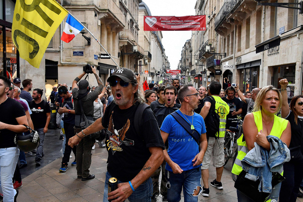 Dua bangunan kantor bank dirusak. Ada pula sepeda motor yang dirusak. Jendela dan properti lain juga ikut rusak. AFP Photo/Georges Gobet