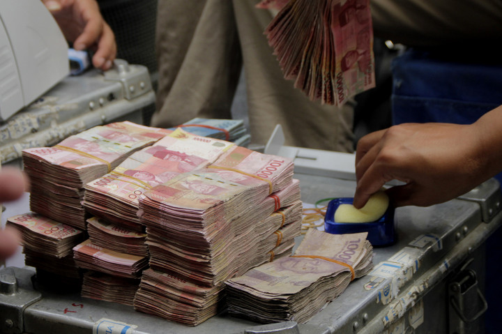 Karyawan Bank Indonesia menyortir uang pecahan Rp100 ribu yang didapatkan dari warga di atas Kapal KRI Hiu 634 di Labuan Bajo, Kabupaten Manggarai Barat, NTT.