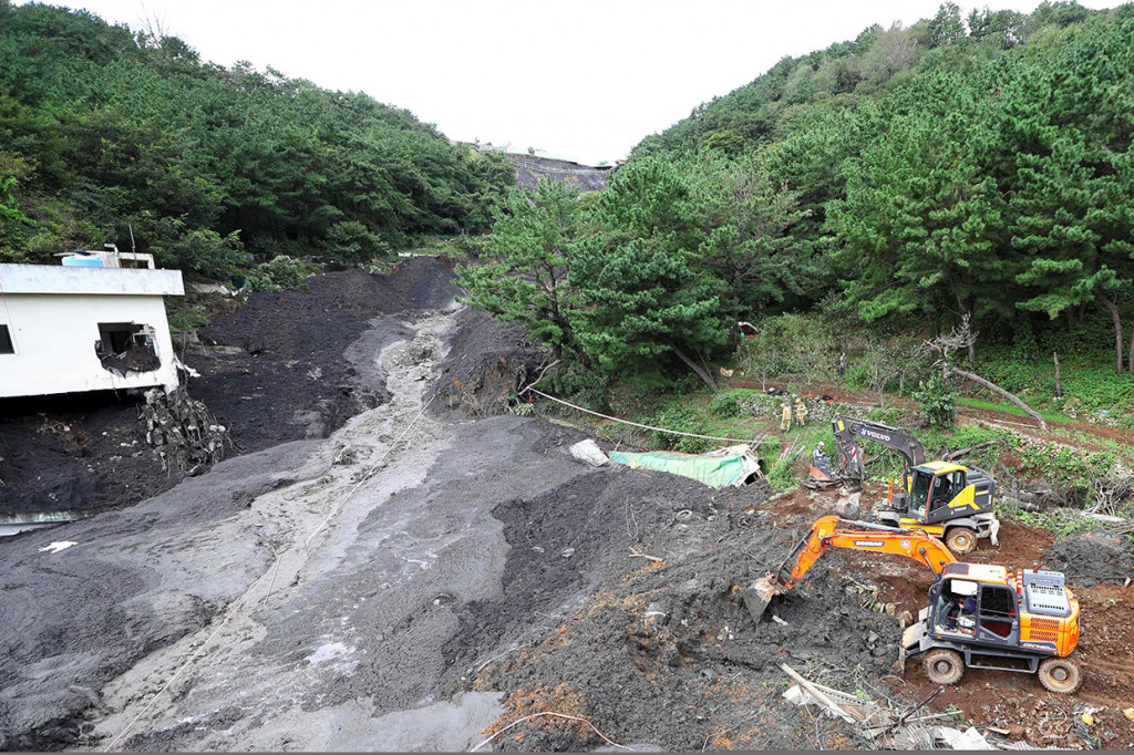Petugas penyelamat mencari korban yang hilang di lokasi longsor setelah topan Mitag melanda wilayah Busan, Korsel, Kamis, 3 Oktober 2019.