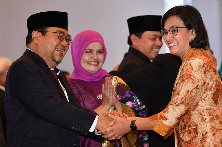 Menteri Keuangan Sri Mulyani (kanan) mengucapkan selamat kepada Anggota Badan Pemeriksa Keuangan (BPK) Harry Azhar Azis (kiri) yang didampingi istrinya Amanah Abdulkadir (kedua kiri) usai Pengucapan Sumpah Jabatan Anggota BPK Periode 2019-2024 di Mahkamah Agung, Jakarta.
