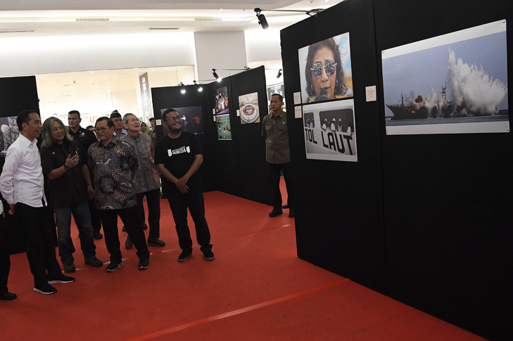 Presiden Joko Widodo (kiri) didampingi Seskab Pramono Anung (tengah), kurator Oscar Motuloh (kedua kiri), Founder Agung Podomoro Group Trihatma Kusuma Haliman (kedua kanan) dan Ketua Panitia Pameran Membangun Indonesia Randi Tri Kurniawan (kanan) menyaksikan karya foto dalam pameran foto Membangun Indonesia di Atrium Neo Soho Mall, Jakarta.