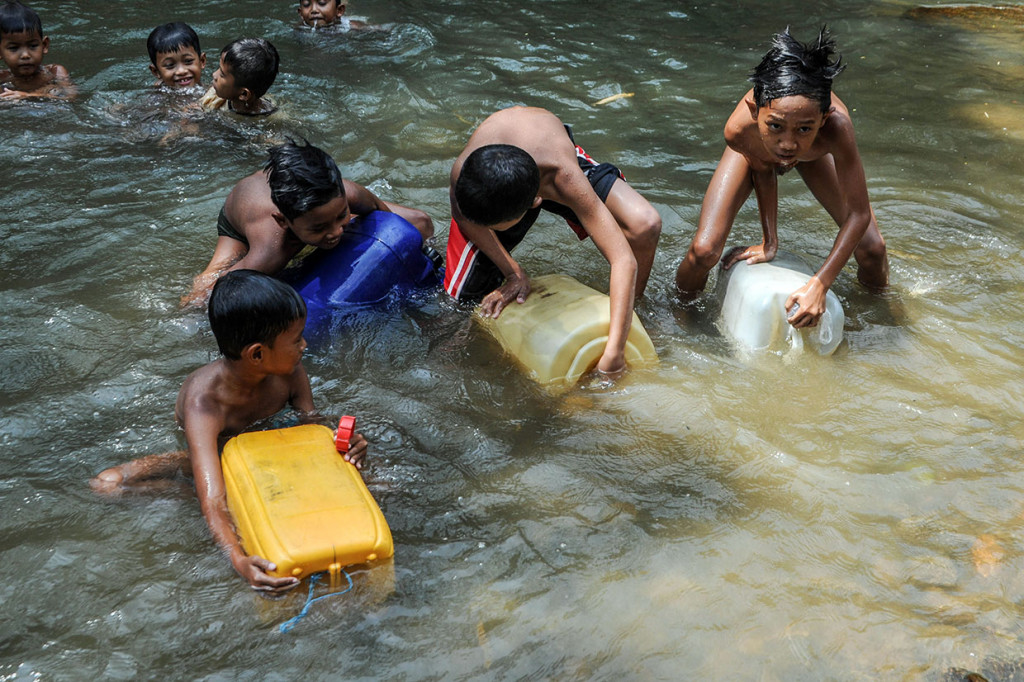 Sejumlah anak mengambil air di sungai yang berjarak 1 kilometer dari permukiman di Desa Leuwi Ipuh, Lebak, Banten, Senin, 18 November 2019.